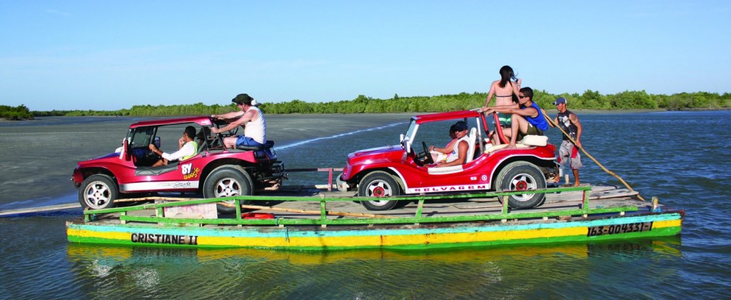 A ferry brings two buggies accross one of the rivers of the Nordeste. 