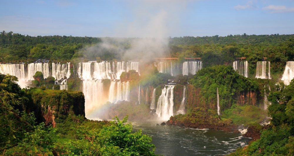 A rainbow forms over the magnificent Iguaçu falls. 