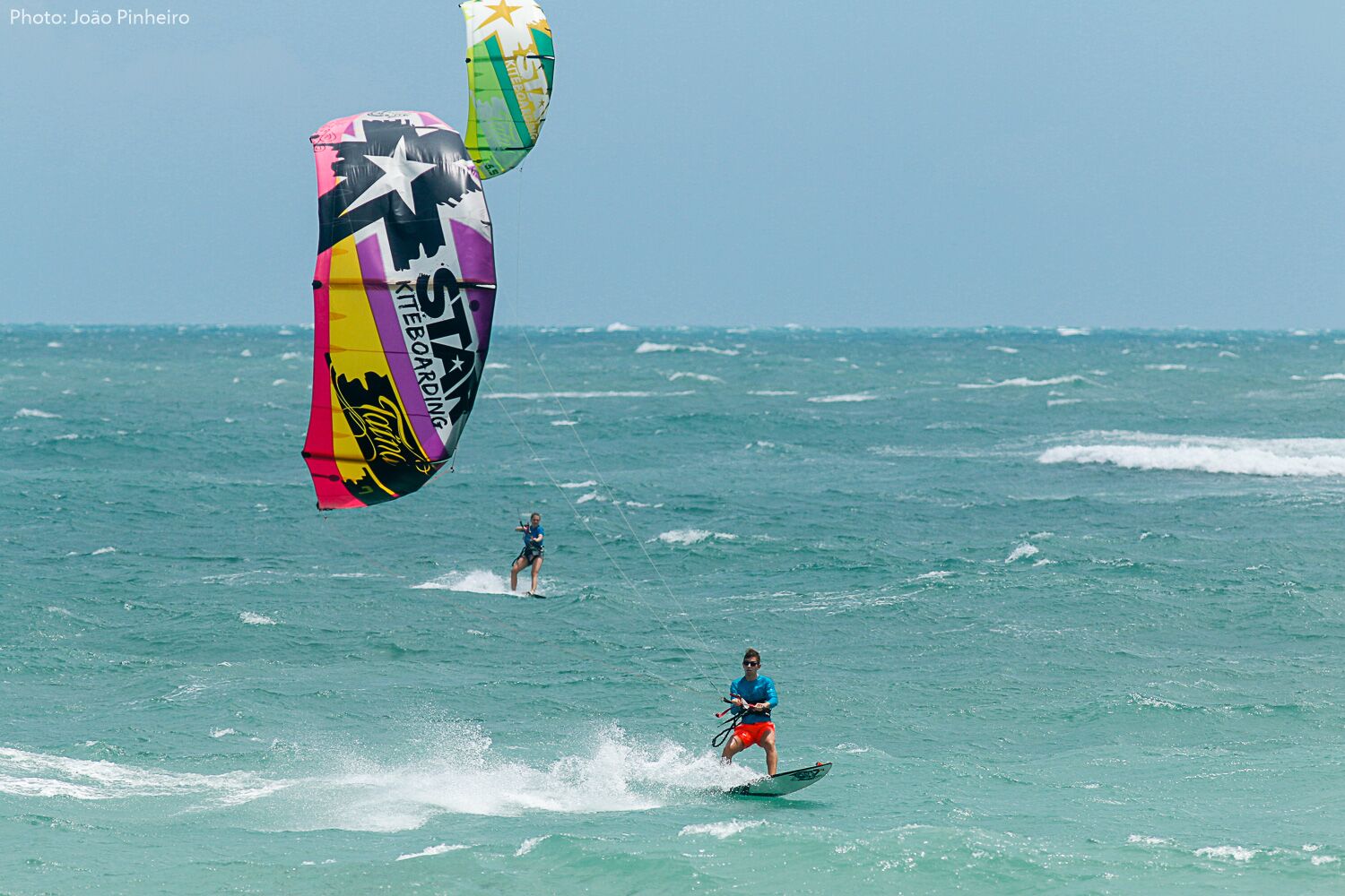 Kitesurfer surfs a surf board in Natal.