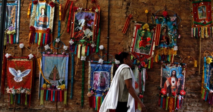 Catholic tapestries hanging on a wall in Brazil.